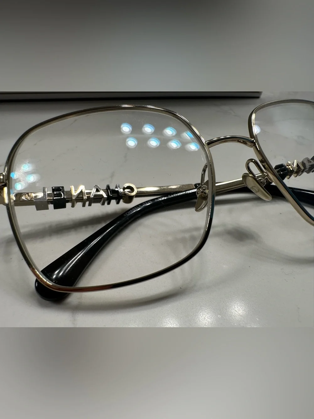 CHANEL Gold Frame Glasses with Black Temple Tips
